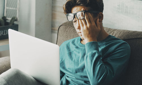 Young man using laptop at home