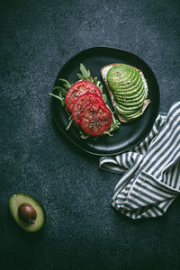 High angle view of avocado on toasted bread in plate