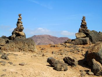 Rock formations on landscape against sky