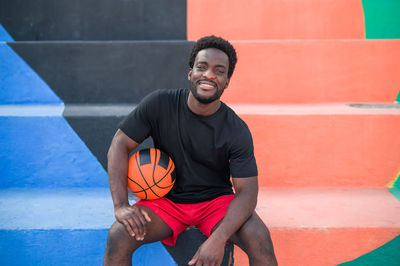 Portrait of basketball player sitting outdoors
