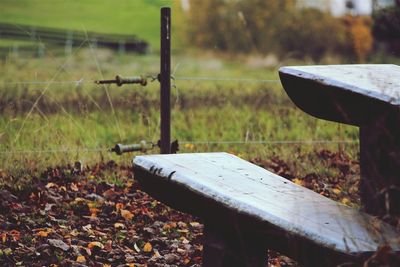 Close-up of wooden fence on field