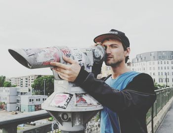 Portrait of young man standing in city