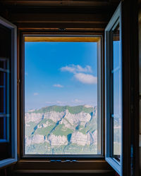 Scenic view of mountains seen through window