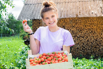 Woman holding fruits in container