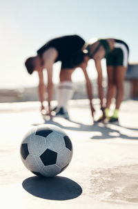 Low section of man holding soccer ball