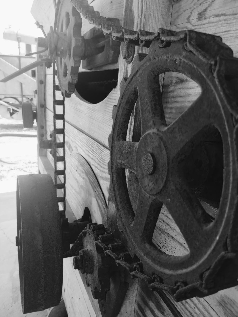 wheel, machinery, steam engine, transportation, no people, aircraft engine, black and white, metal, industry, machine part, day, vehicle, equipment, iron, monochrome, gear