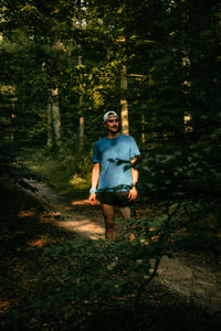 Rear view of man standing in forest