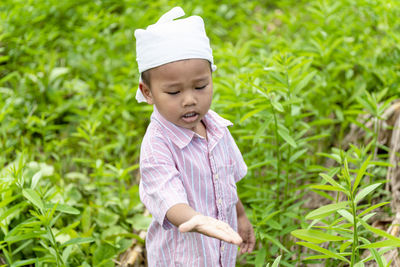 Boy standing on field