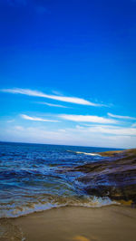 Scenic view of sea against blue sky