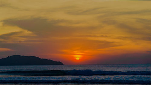 Scenic view of sea against romantic sky at sunset