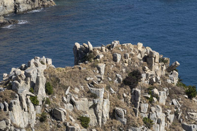 Panoramic view of cliff by sea against sky