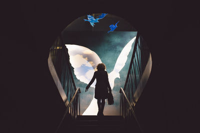 Digital composite image of woman on staircase against flying bird