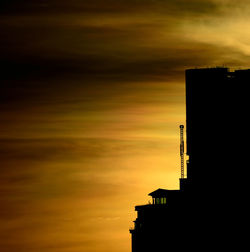 Low angle view of building against cloudy sky