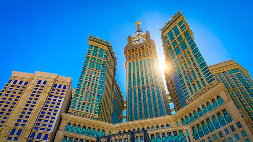 Low angle view of modern buildings against blue sky