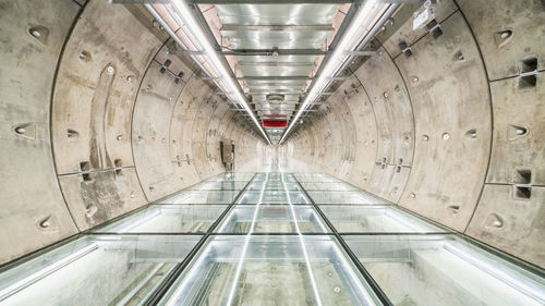 Illuminated empty tunnel of subway station