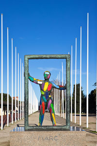 Full length of man standing against blue sky