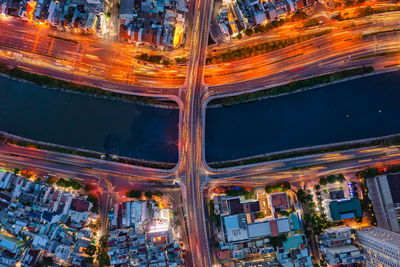 High angle view of city lit up at night