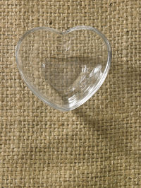 Directly above shot of heart shape bowl on burlap