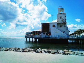 Building by sea against sky