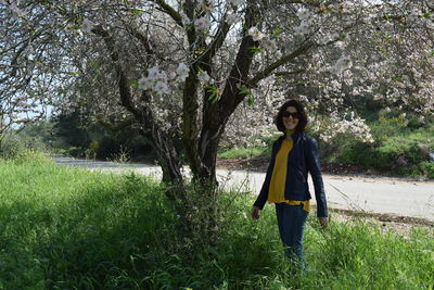 Rear view of woman standing on grass
