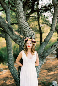 Portrait of young woman standing in forest