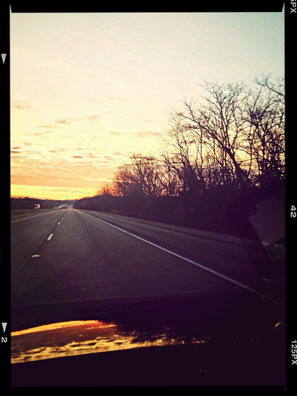 transportation, sunset, road, tree, silhouette, sky, the way forward, transfer print, bare tree, car, orange color, auto post production filter, diminishing perspective, land vehicle, windshield, road marking, landscape, country road, scenics, dusk