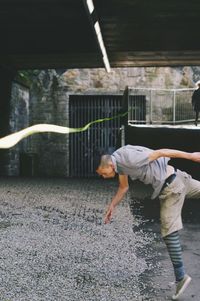 Full length of woman standing by railing