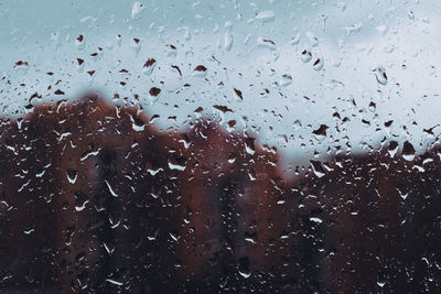 Full frame shot of raindrops on glass window