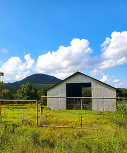 Built structure on field against sky