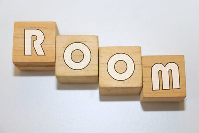 Close-up of wooden block with text over white background