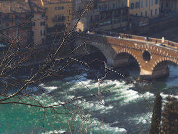 Bridge over river amidst buildings in city