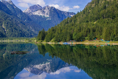 Scenic view of lake by mountains against sky