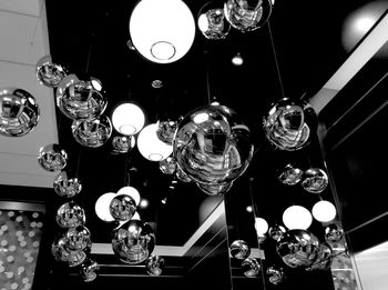 Low angle view of illuminated chandelier hanging from ceiling