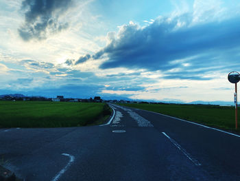 Empty road along countryside landscape