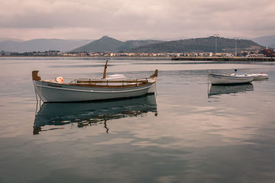 Boats moored on sea against sky