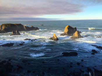 Rocks in sea against sky