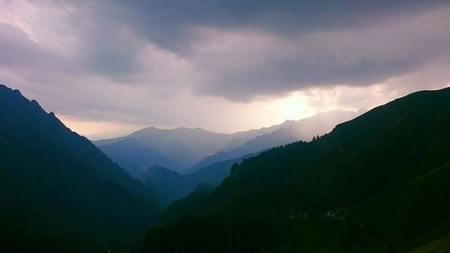 Scenic view of silhouette mountains against sky at dusk