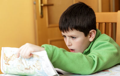 Portrait of boy sitting at home