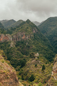 High angle view of valley and mountains against sky