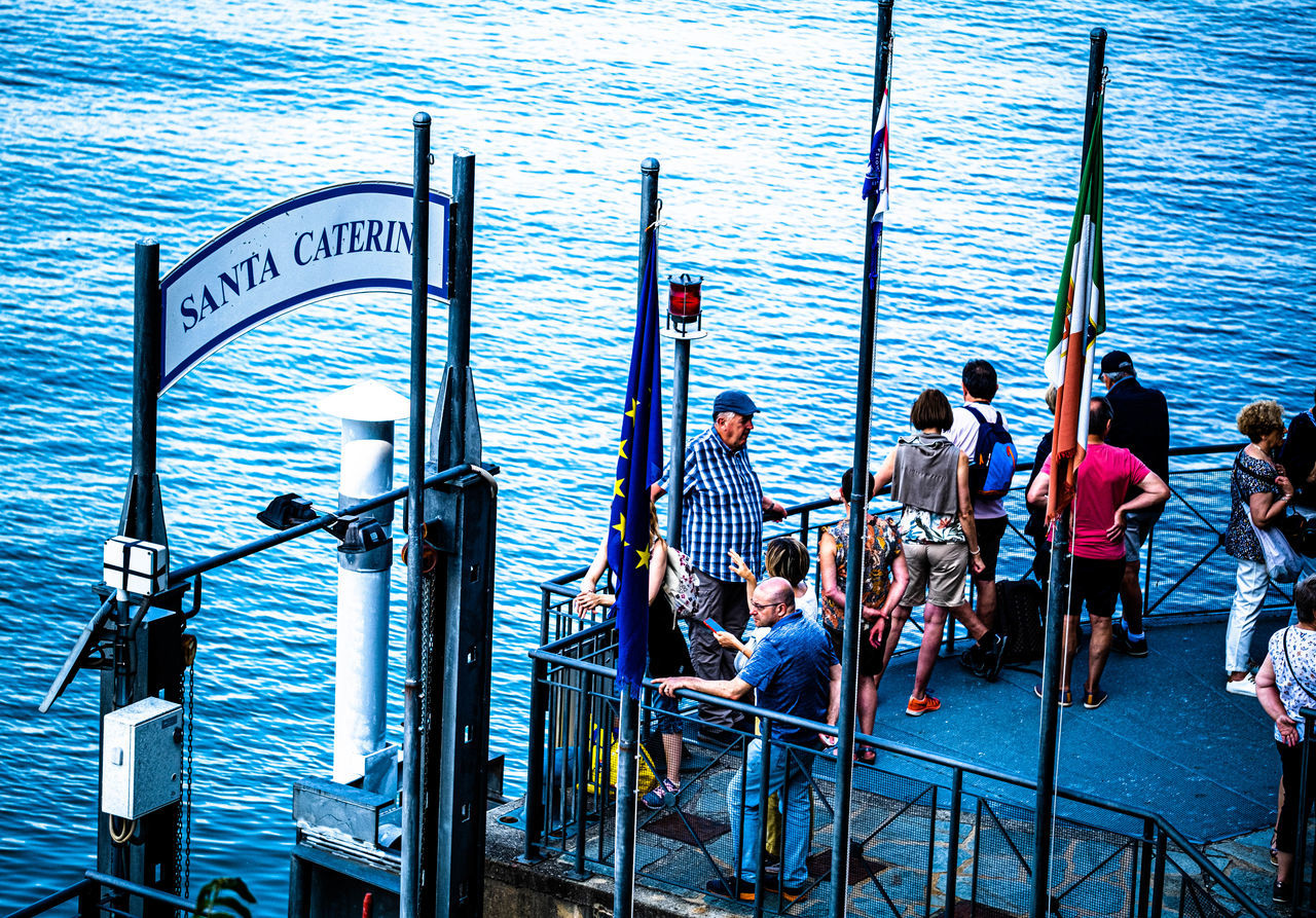 group of people, water, men, sea, railing, women, transportation, nautical vessel, day, nature, adult, mode of transportation, outdoors, lifestyles, blue, person, leisure activity, vehicle, ship, crowd, travel, architecture