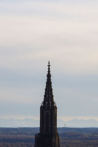 Tower of church against cloudy sky