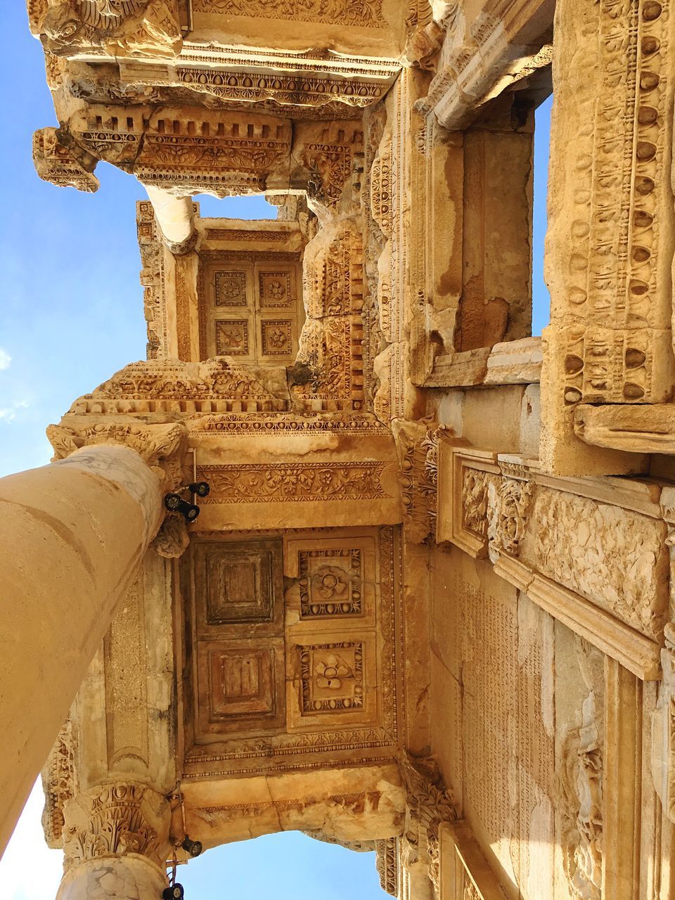 architecture, built structure, low angle view, travel destinations, building exterior, history, sky, religion, human representation, place of worship, statue, day, outdoors, spirituality, no people, sculpture, architectural column, bas relief