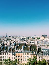 Cityscape against clear blue sky