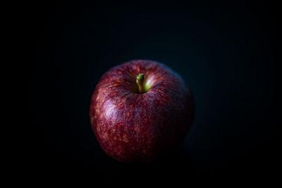Close-up of apple against black background