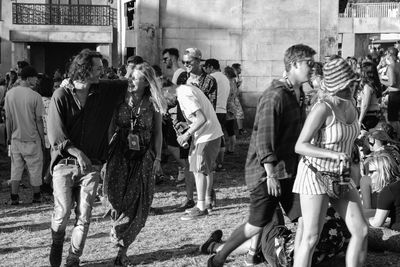 Side view of people looking at market stall