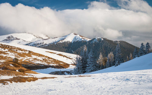 Scenic view of snowcapped mountains against sky