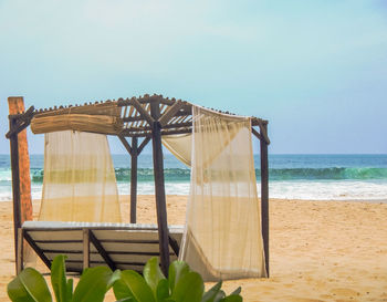 Built structure on beach against clear sky