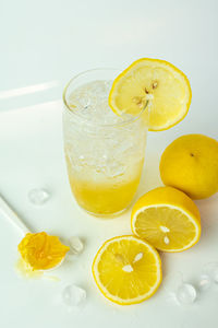 Yellow drink on table against white background