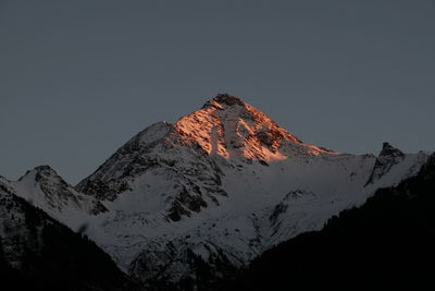 Low angle view of illuminated mountain against sky at night