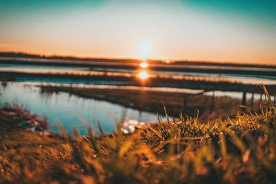 Scenic view of lake against sky during sunset